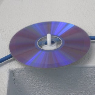 A cd on a white surface
AI-generated content may be incorrect.