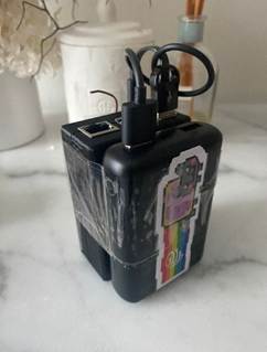 A black device with a sticker on it
AI-generated content may be incorrect.